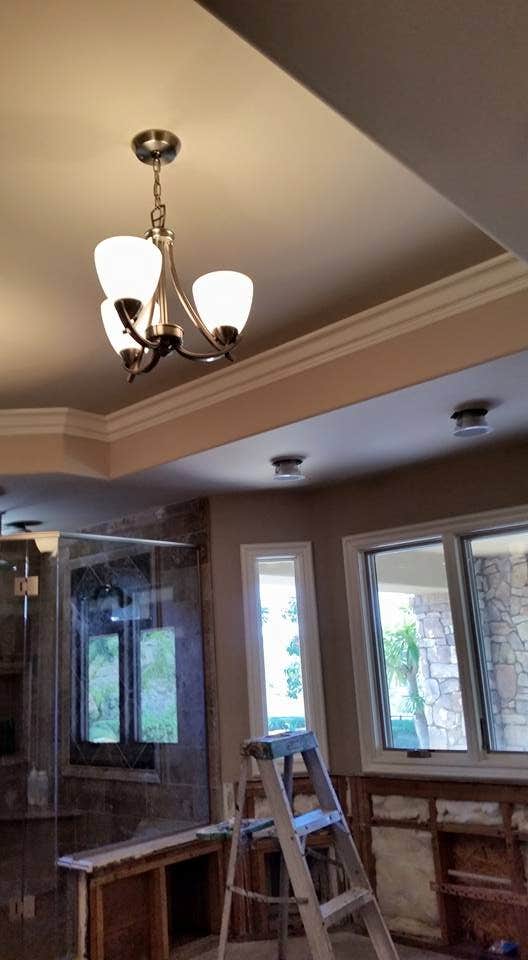 Interior renovation with trim and ceiling painting in progress