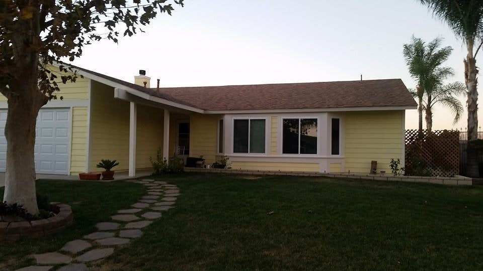 Finished residential exterior in a warm yellow and white palette