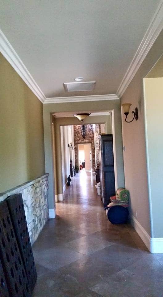 Finished interior hallway with clean walls, ceiling, and trim